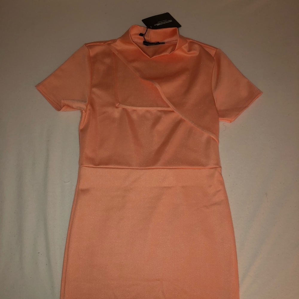 Beautiful mini dress with a cut on the top. Size large. Brand new.